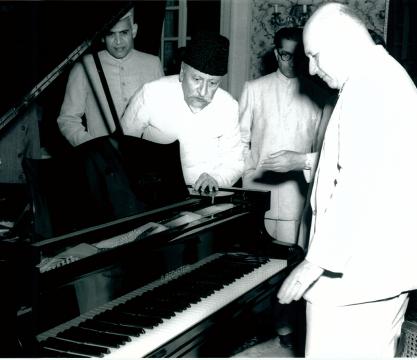 H. E. Mr. E. W. Meyar, Ambassador of the Federal Republic of Germany to Indian presented a piano to the Ministry of Education, Government of India, at a ceremony held in New Delhi on November 2, 1956, as a token of appreciation for Indian Music. Photo shows Maulana Abul Kalam Azad Union Education Minister, receiving the gift from H. E. Mr. E. W. Meyor (at right in the picture)