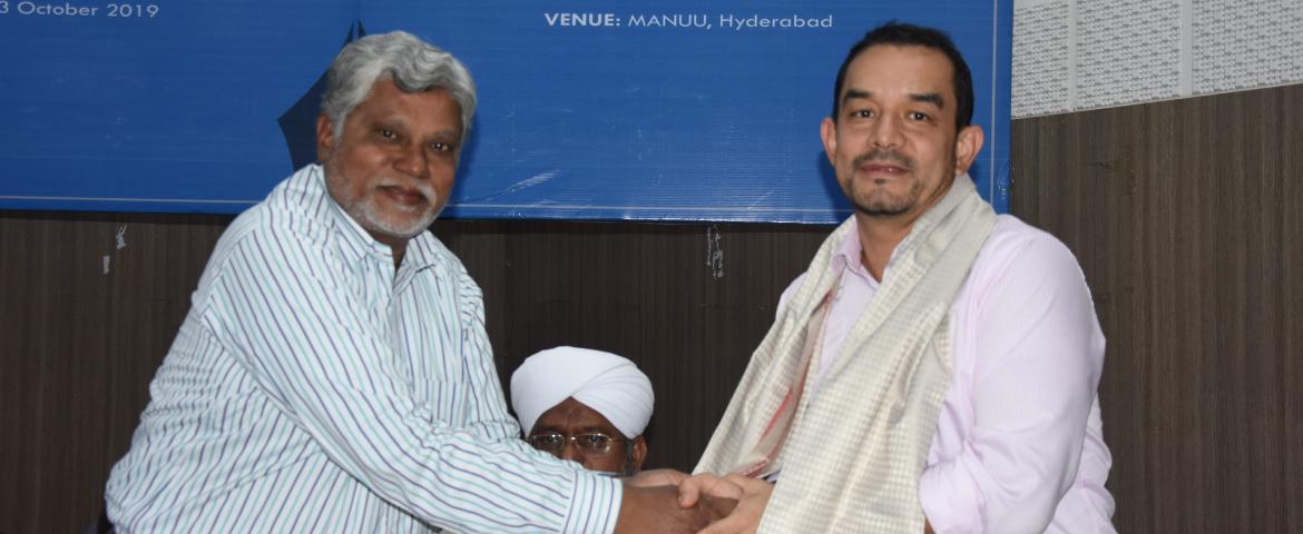 Prof.  S M Rahmatullah  presenting shawl to Mr. Siddhartha Shrestha 