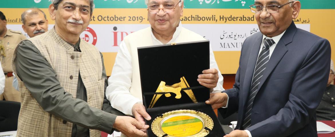  Dr. Mohammad Aslam Parvaiz and Mr. Shakeel Ahmed Sabrhadi presenting memento to Arif Mohammad Khan