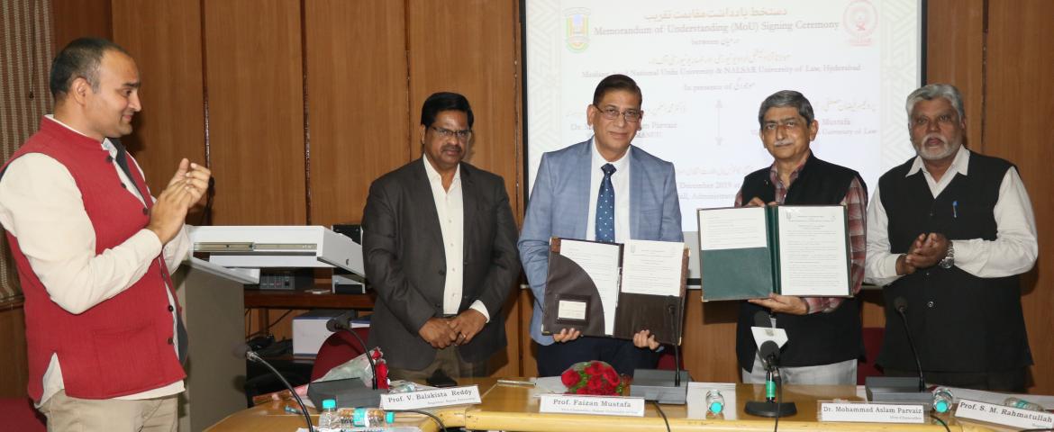 Showing: Dr. Mohammad Aslam Parvaiz and Prof. Faizan Mustafa showing the MoU. Prof. S. M. Rahmatullah, Prof. V. Balakista Reddy and Mr. Rizwan Ahmad are also seen.