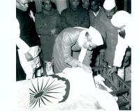 Shri U. N. Dhebar, garlanding the body of Maulana Sahib with Khadi thread, the body was laying in State at his official residence in New Delhi on February 22, 1958